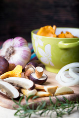 Sliced boletus with chanterelle and onion. Cooking musrooms