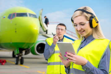 Airport workers with airplane on the background