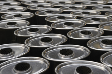 Industrial background. Stacks of new exhausts and silencers mufflers car before distribution and...