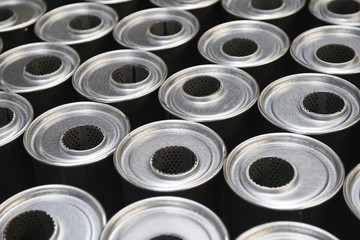 Industrial background. Stacks of new exhausts and silencers mufflers car before distribution and retail. Detail of a new automotive components in stainless steel. Close up.