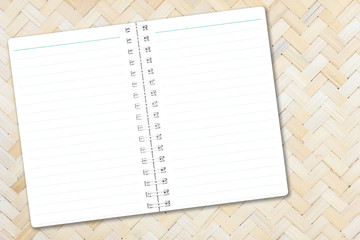 Open notebook paper with line on bamboo weave background for design with copy space for text or image.
