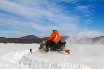 Athlete on a snowmobile.