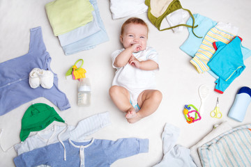 Baby on white background with clothing, toiletries, toys and health care accessories. Wish list or...