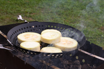 The squash are roasting on the coals