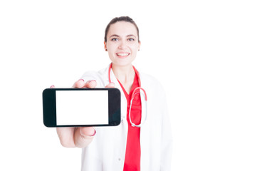 Cheerful medic holding mobilephone