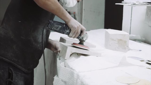 Worker polishing marble stone , close up