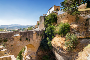 Fototapeta na wymiar Buildings on the cliffside of El Tajo Gorge in Ronda, Malaga province, Spain.