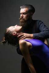 Man holds neck of woman