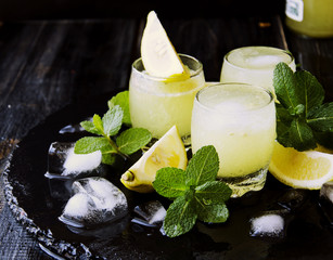 limoncello,Italian traditional liqueur with lemons on the vintage table