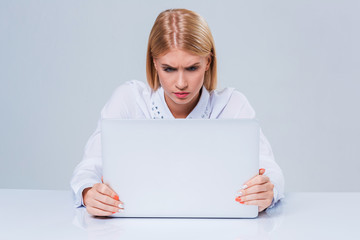 Young businesswoman working at laptop computer.