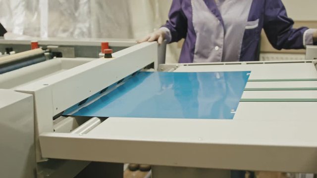 industrial printing process - worker monitors the printing process, close up
