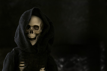 Grim reaper skeleton on black background