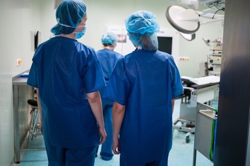 Fototapeta na wymiar Surgeons walking in operation room