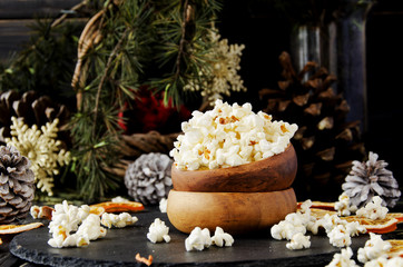 popcorn in a wooden plate on the background of Christmas