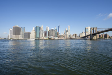 Fototapeta na wymiar Downtown Manhattan skyline view from Brooklyn of the Brooklyn Bridge with East River in New York City