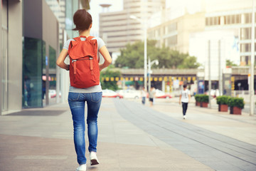 young asian woman walking on city street