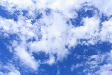 Blue sky background with white clouds. The vast blue sky and clouds sky on sunny day. White fluffy clouds in the blue sky.