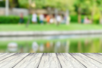 perspective white wood table with blur background of people do sport at a park 