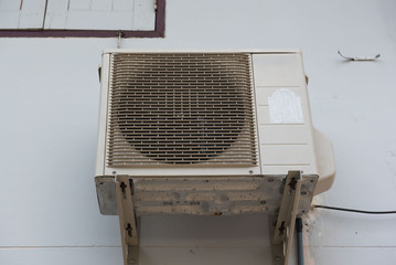 Old air compressors is located behind the wall home.
