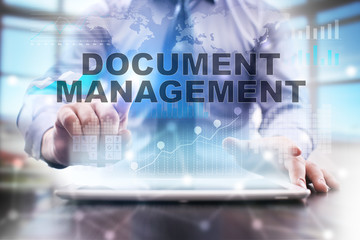 Businessman is using tablet computer, pressing button on touch screen and selecting 