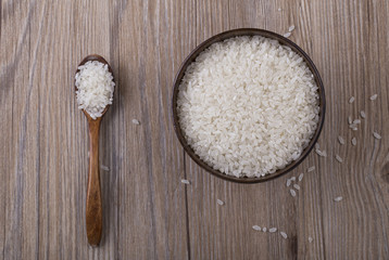 Rice in wooden bowl on the table for food background