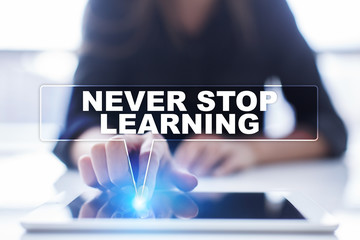 Woman is using tablet pc, pressing on virtual screen and selecting "Never stop learning".