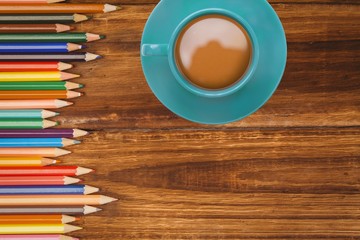 Cup of coffee with pencils on desk