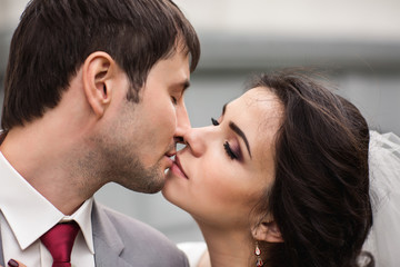 Wedding kiss. Close-up portrait of bride and groom