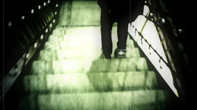 A man is being followed down a flight of stairs to the subway. With glitches,grunge and scratches.