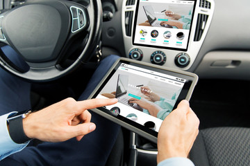 close up of man with tablet pc in car