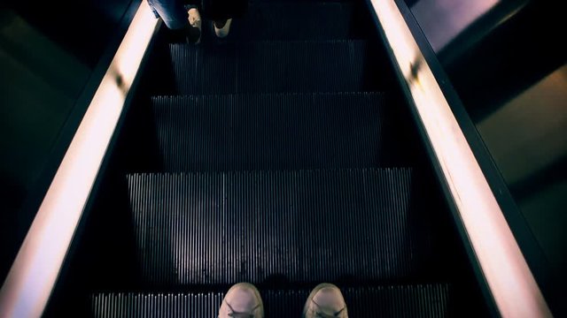 Riding down the escalator not holding the guardrails.
