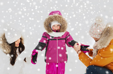 happy family with child in winter clothes outdoors