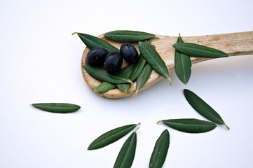 Fresh olives with leaves and  wooden spoon  on White Background
