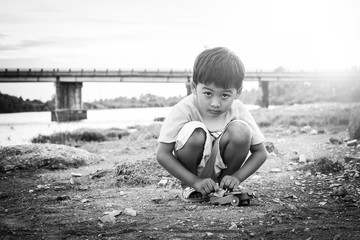 Cute little asian child boy  playing outdoor black and white ton