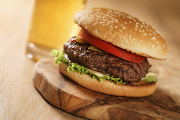 homemade hamburger with beer on background