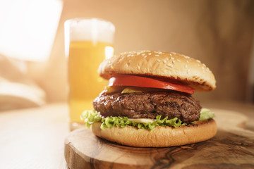 homemade hamburger with beer on background