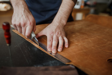 Close-up. Male hand master work with the skin. Small business