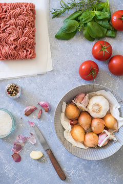 Ingredients for bolognese sauce: ground meat, tomato, onion, garlic, herbs and seasonings