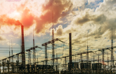 coal power plant with big chimneys and electrical substation on the front.