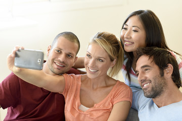 Obraz premium Group of friends taking selfie pictures with smartphone