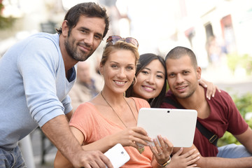 Fototapeta premium Young people websurfing on digital tablet to find apartment