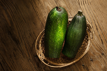 zucchini in a basket on table