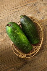 zucchini in a basket on table
