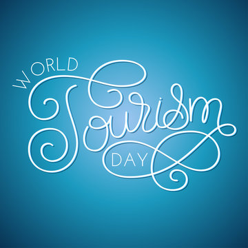World tourism day hand lettering on blue background