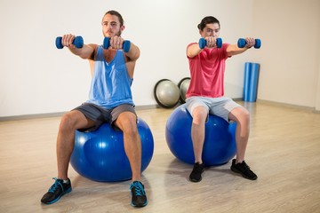 Fototapeta na wymiar Men exercising on exercise ball