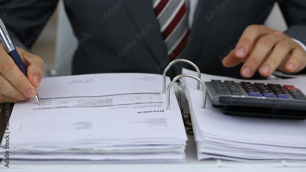 Poster close-up of a businessman calculating financial expenses using calculator