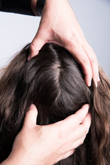 Fototapeta premium Hair Stylist checking out scalp