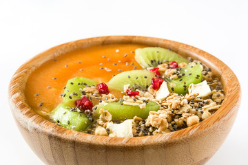 Healthy smoothie with fruit, cereals and chia seeds in a bowl isolated on white background

