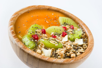 Healthy smoothie with fruit, cereals and chia seeds in a bowl isolated on white background

