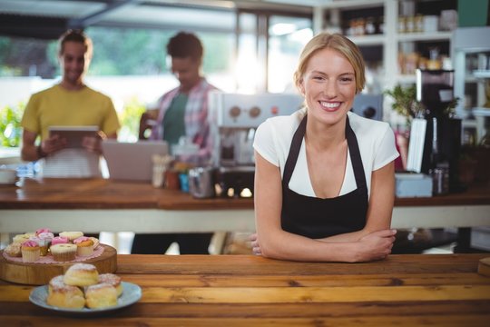 Portrait Of Waitress Standing Behind The Counter